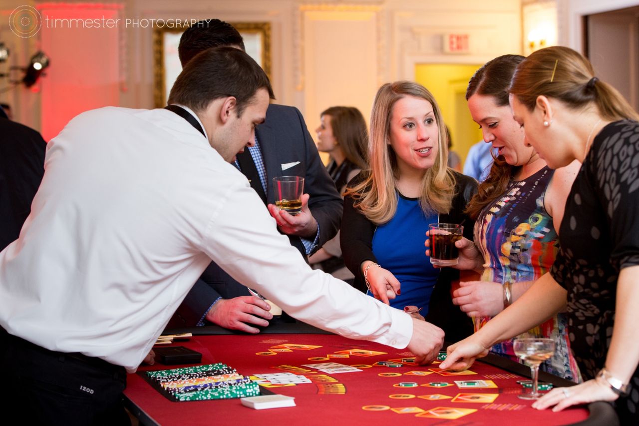 Guests playing a casino table game with a Metro Casino dealer