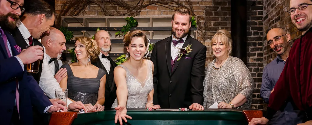 Wedding guests gathered around a casino table