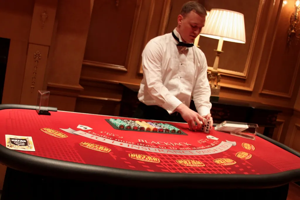 Dealer arranging cards at a blackjack table