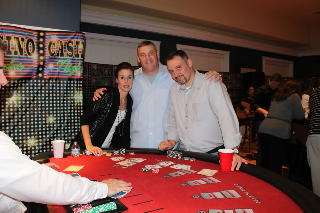 Guests gathered around a blackjack table
